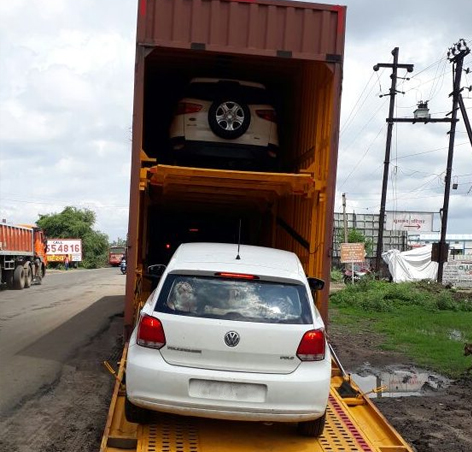 A professional team carefully packing boxes and preparing for relocation alongside a branded white moving truck.